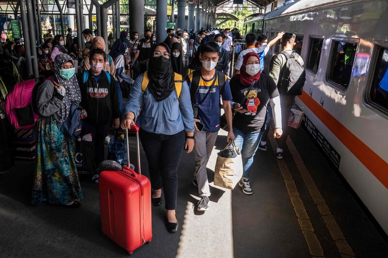 Passengers prepare to board a train in Surabaya, Indonesia, as people head home for the Eid holiday. AFP