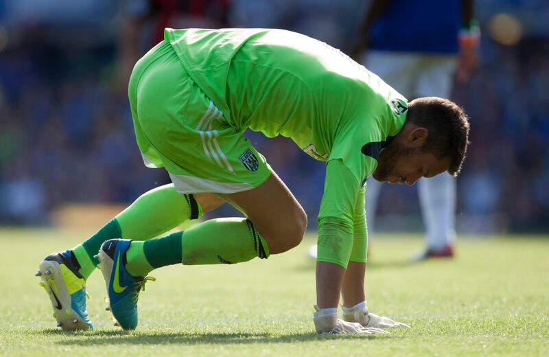West Bromwich Albion's goalkeeper Ben Foster falls to the pitch after being injured during his team's English Premier League soccer match against Everton at Goodison Park Stadium, Liverpool, England, Saturday Aug. 24, 2013. (AP Photo/Jon Super) *** Local Caption ***  Britain Soccer Premier League.JPEG-0fe53.jpg