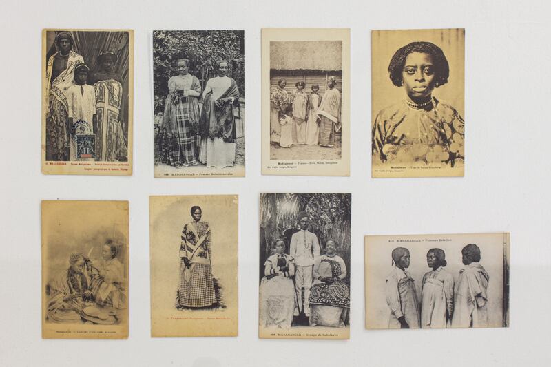 Installation view of postcards depicting people wearing lamba