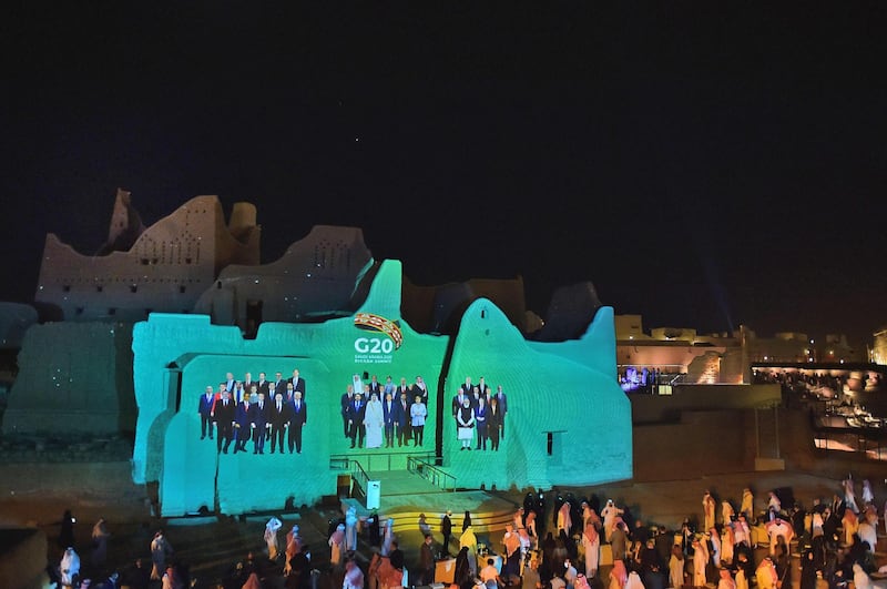 A family photo of G20 Leaders is projected at the historic site of al-Tarif in Diriyah district, on the outskirts of Saudi capital Riyadh, ahead of G20 virtual summit. Saudi Arabia hosts the G20 summit Saturday in a first for an Arab nation, with the downsized virtual forum dominated by efforts to tackle a resurgent coronavirus pandemic and crippling economic crisis. AFP