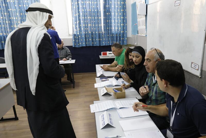 An Arab Israeli man registers before voting in Israel's parliamentary elections. AFP