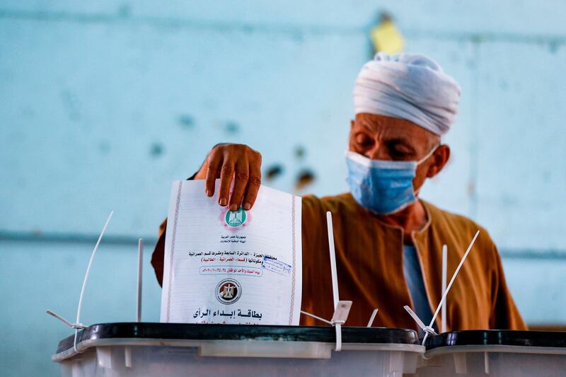 A man casts his vote at a polling station in the Talibeya district of Giza, the twin-city of Egypt's capital while voting in the first stage of the lower house elections. AFP