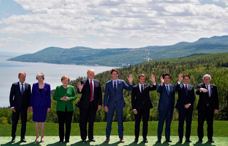 G7 leaders pose for a group photo at the start of their annual summit on June 8, 2018 in La Malbaie, Canada. From left: European Council President Donald Tusk; British Prime Minister Theresa May; German Chancellor Angela Merkel; US President Donald Trump; Canadian Prime Minister Justin Trudeau; French President Emmanuel Macron; Japanese Prime Minister Shinzo Abe; Italian Prime Minister Giuseppe Conte; and European Commission President Jean Claude Juncker.  AFP