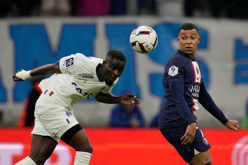 Marseille's Eric Bailly, left, duels for the ball with PSG's Kylian Mbappe. AP Photo