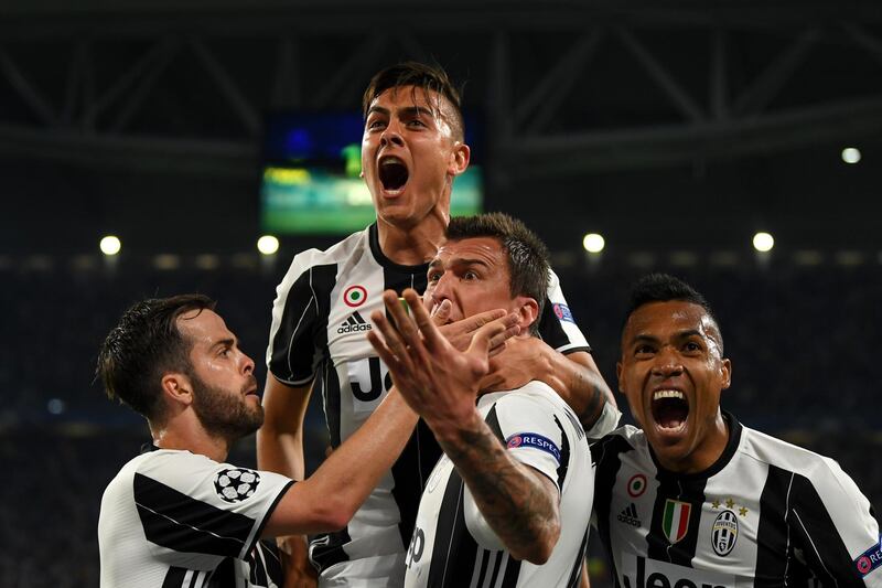 TURIN, ITALY - APRIL 11:  Paulo Dybala of Juventus celebrates with Miralem Pjanic, Mario Mandzukic and Alex Sandro of Juventus after scoring his team's second goal during the UEFA Champions League Quarter Final first leg match between Juventus and FC Barcelona at Juventus Stadium on April 11, 2017 in Turin, Italy.  (Photo by Mike Hewitt/Getty Images)