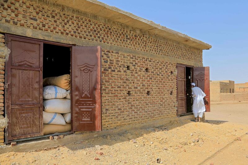 Sudanese farmer Modawi Ahmed outside his granary.
