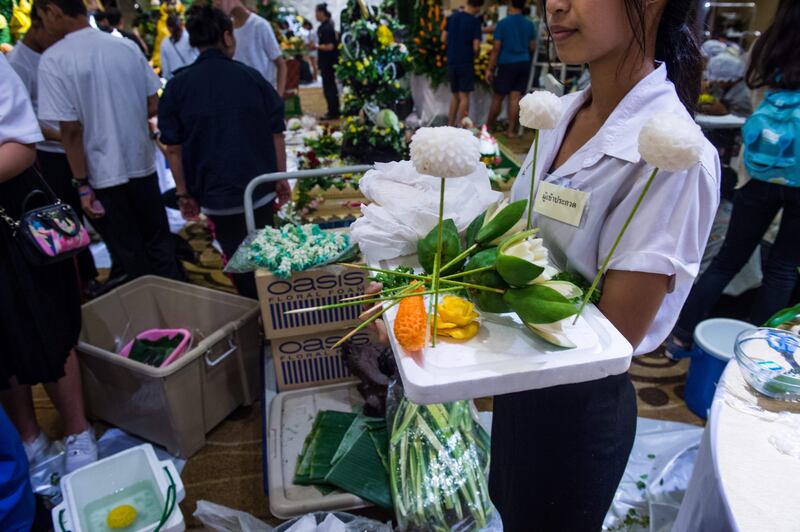 A Thai woman holds a tray with carved fruit and vegetable decorations during a fruit and vegetable carving competition in Bangkok. Robert Schmidt / AFP