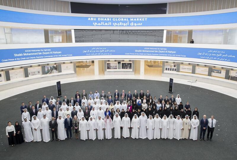 The delegation led by the Abu Dhabi Crown Prince pose for a photo with ADGM employees. Mohamed Al Hammadi / Crown Prince Court - Abu Dhabi