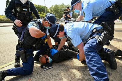 Police make an arrest during an anti-lockdown protest in Sydney on Saturday. Photo: AP
