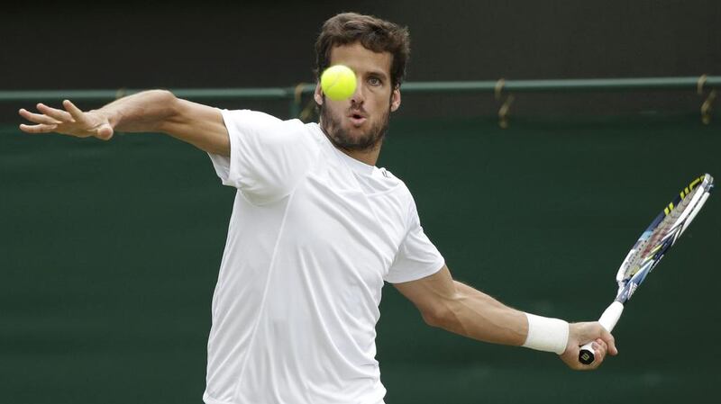 Feliciano Lopez of Spain hits a return to John Isner of the US during their singles match on Monday at the 2014 Wimbledon Championships. Lopez won in four sets. Max Rossi / Reuters