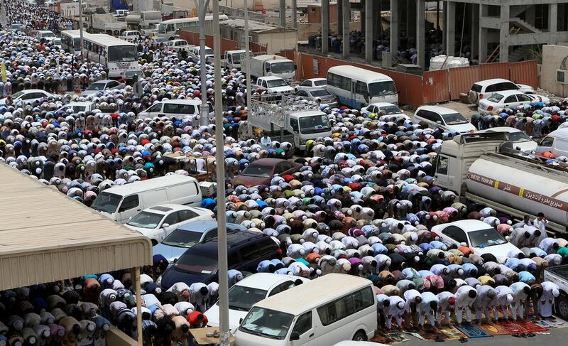 People pray outside a mosque in Mussffah Industrial area due to insufficient capacity. (Ravindranath K / The National)
