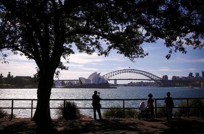 Tourists take photographs as they stand in front of the Sydney Harbour Bridge and Sydney Opera House in Australia, November 13, 2018.    REUTERS/David Gray
