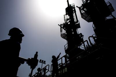 Workers transfer liquefied natural gas between ships in Karachi, Pakistan. Bloomberg

