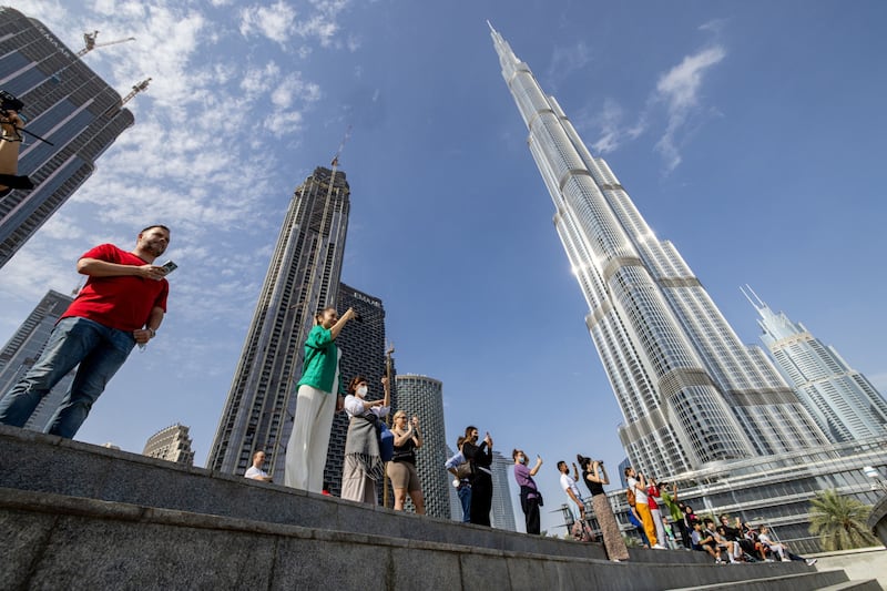 Tourists watching the water fountain display near the Burj Khalifa in Dubai. Bloomberg