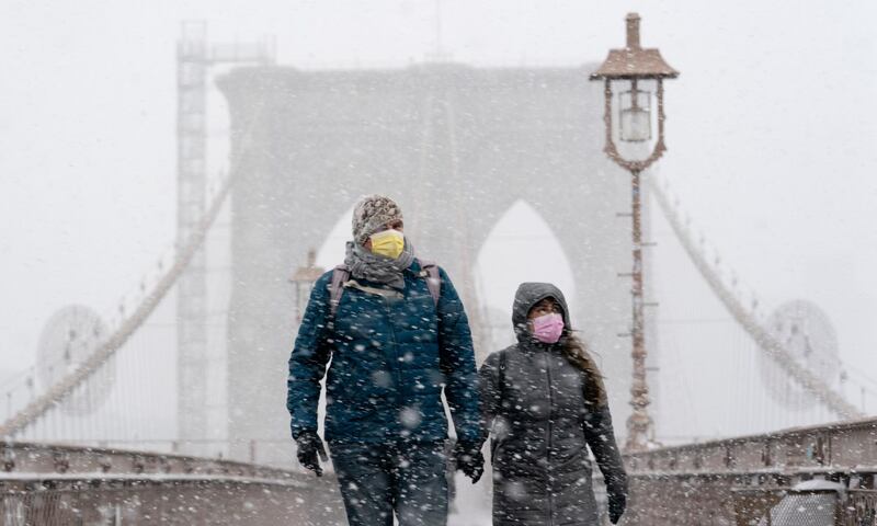 A couple walks on the Brooklyn Bridge on Monday, February 1, 2021. A winter snowstorm walloped the Eastern US on Monday. AP