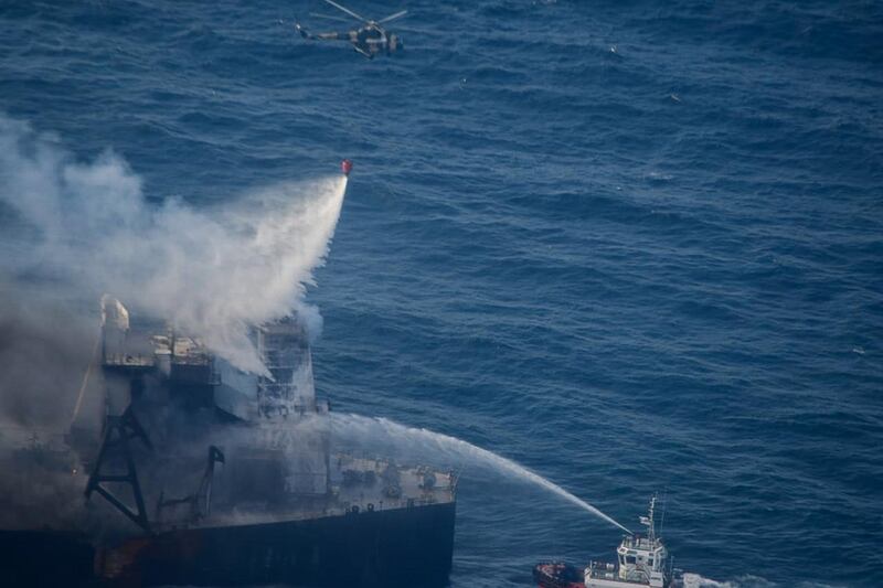 The military helicopter, coast guard ships and fireboats battle to extinguish the fire from MT New Diamond at off the east coast of Sri Lanka. EPA