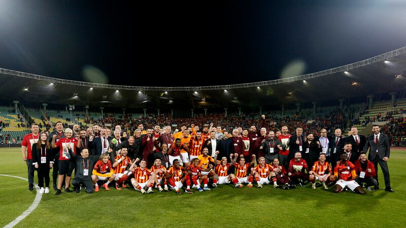 Galatasaray players and staff celebrate winning the Turkish Super Cup final after Fenerbahce players walked off, leading to the match being abandoned. Reuters