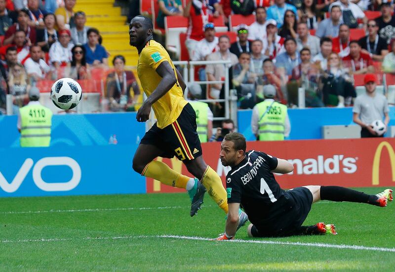 Belgium's Romelu Lukaku, left, scores their side's third goal past Tunisia goalkeeper Farouk Ben Mustapha during the group G match between Belgium and Tunisia at the 2018 soccer World Cup in the Spartak Stadium in Moscow, Russia, Saturday, June 23, 2018. (AP Photo/Hassan Ammar)