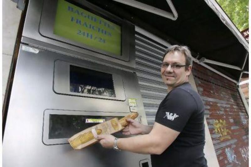 French baker Jean-Louis Hecht shows off his instant baguette dispenser in Paris this week. He says his 24-hour automated dispenser offers warm, fresh bread to hungry night owls, graveyard shift workers and those who missed his regular opening hours.