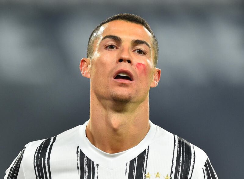 Cristiano Ronaldo wearing red face paint to raise awareness of domestic violence against women. Reuters