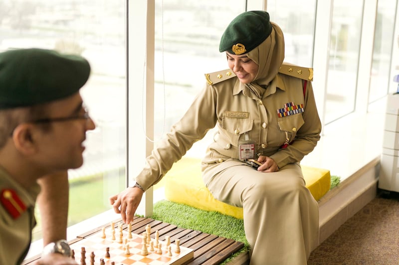 Officers Laila Mohammed Bilkhairi and Yousef Hassan Abdul Nasser play a game of chess.