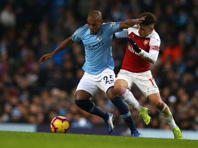 Manchester City's Fernandinho, left, and Arsenal's Lucas Torreira challenge for the ball during the English Premier League soccer match between Manchester City and Arsenal at Etihad stadium in Manchester, England, Sunday, Feb. 3, 2019. (AP Photo/Dave Thompson)