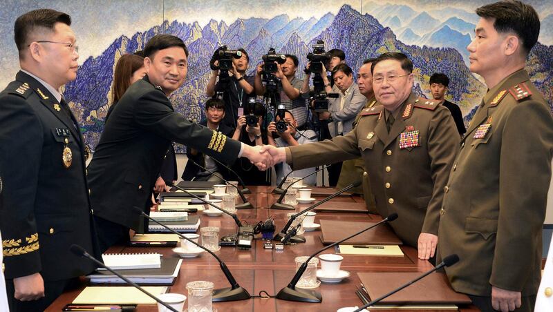 North Korean Lt Gen An Ik San, second from right, shakes hands with South Korea's Maj Gen Kim Do-gyun during a meeting inside the Peace House at the border village of Panmunjom in 2018.