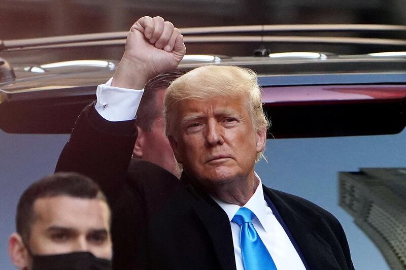 Former U.S. President Donald Trump acknowledges people as he gets in his SUV outside Trump Tower in the Manhattan borough of New York City, New York, U.S., March 9, 2021. REUTERS/Carlo Allegri     TPX IMAGES OF THE DAY