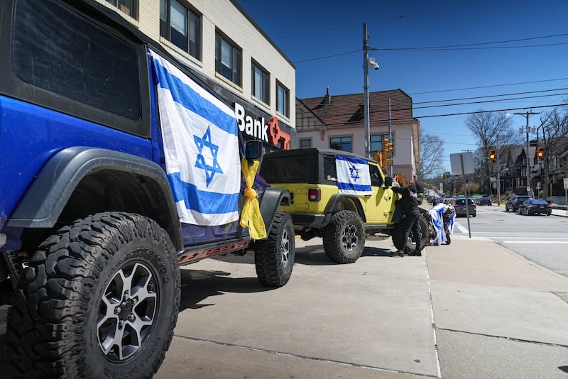 Israeli flags are draped from car windows in Squirrel Hill