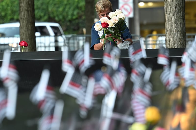 A woman places flowers at the South Tower ahead of ceremonies to mark the 20th anniversary of the 9/11 attacks. EPA