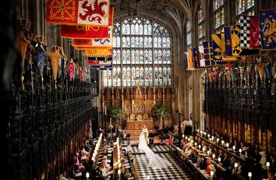 Prince Harry and Meghan Markle in St George's Chapel at Windsor Castle during their wedding service, conducted by the Archbishop of Canterbury Justin Welby in Windsor, Britain, May 19, 2018. Owen Humphreys/Pool via REUTERS     TPX IMAGES OF THE DAY