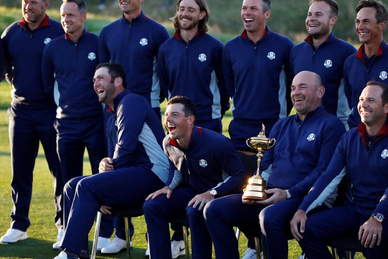 Team Europe captain Thomas Bjorn, John Rahm and Rory McIlroy during the team photo with the Ryder Cup. Paul Childs / Reuters