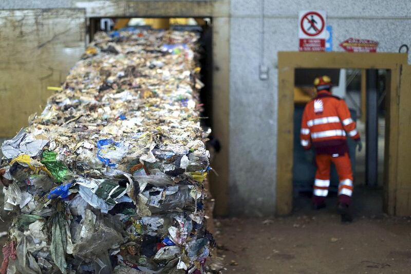 An employee at the Malagrotta landfill near Rome in December 2013. Italian businessman Manlio Cerroni, who built a global empire and a personal fortune on trash, faces trial over allegations he monopolised trash disposal in and around the Italian capital using a web of companies and individuals. Alessandro Bianchi / Reuters