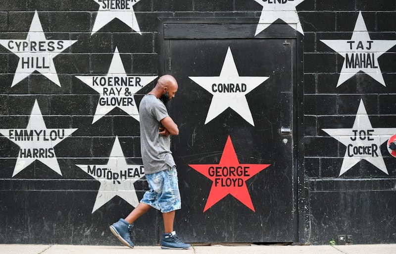 A person walks past the George Floyd star on the wall of the First Avenue rock club in Minneapolis, Minnesota, USA. EPA