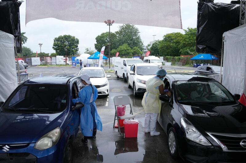 Healthcare workers inoculate people with the AstraZeneca coronavirus vaccine outside the Rommel Fernandez Stadium in Panama City, Panama. AP