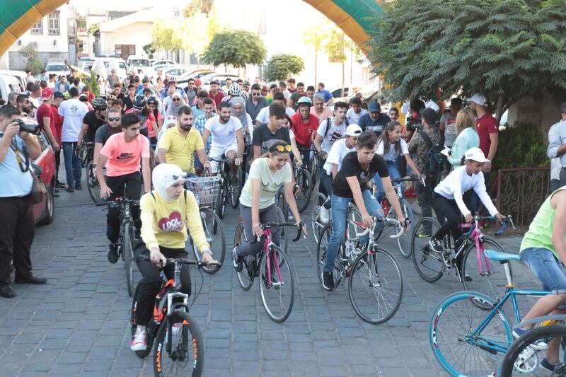 Syrian youths ride on bicycles as part of an event titled 'al-Sham gathers us', that has started from the old city of Damascus towards Tishrin Park, in Damascus, Syria.  EPA