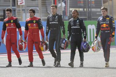(L to R) Ferrari's Monegasque driver Charles Leclerc, Ferrari's Spanish driver Carlos Sainz Jr, Mercedes' British driver George Russell, Mercedes' British driver Lewis Hamilton and Red Bull's Dutch driver Max Verstappen pose for a picture during the first day of Formula One (F1) pre-season testing at the Bahrain International Circuit in the city of Sakhir on March 12, 2021.  (Photo by Mazen Mahdi  /  AFP)