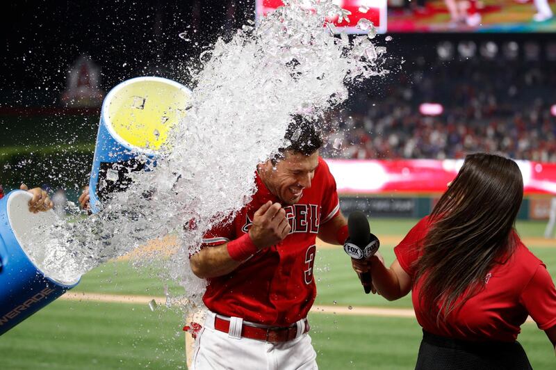 Los Angeles Angels' Ian Kinsler is doused in water by teammates to celebrate his ninth-inning walk off single against the Los Angeles Dodgers in a baseball game in Anaheim, California. Jae C. Hong/AP Photo