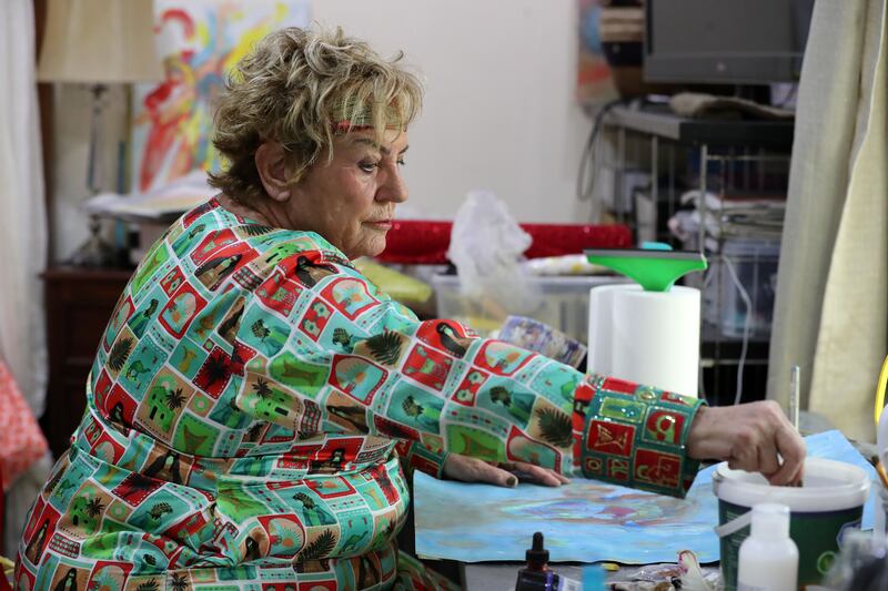Musch puts the final touches to some of her paintings