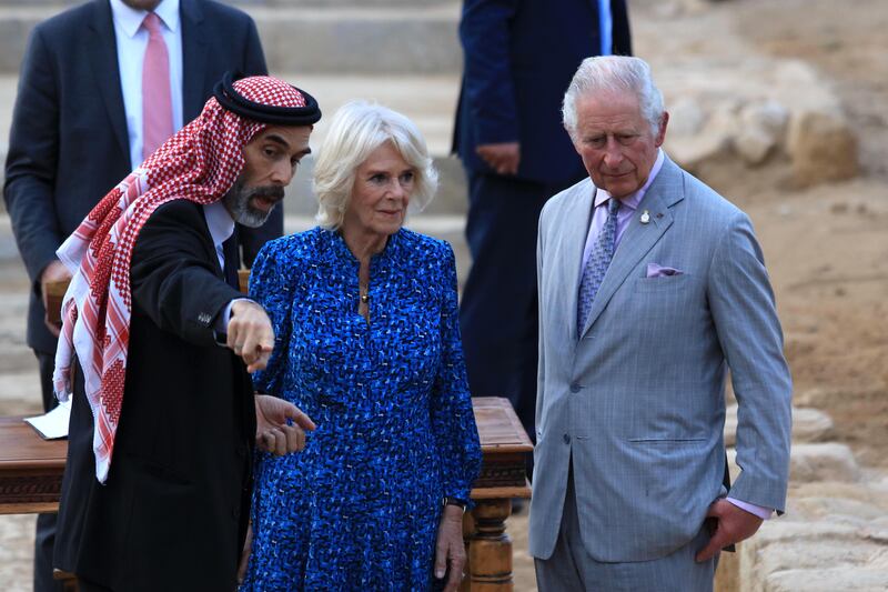 The royals listen to a tour guide during their visit to Al Maghtas. EPA