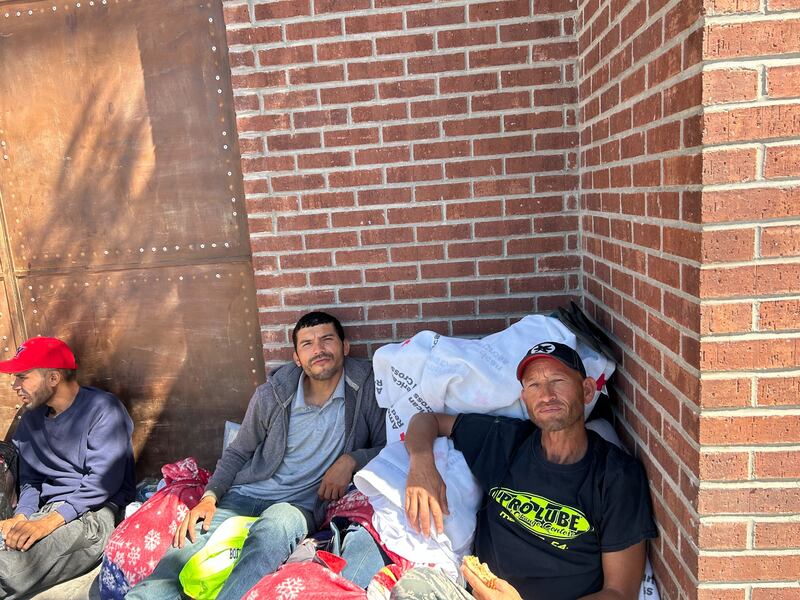 Venezuelan migrants sit outside the Sacred Heart Church
