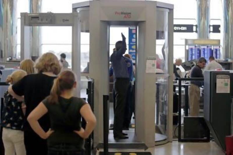 Passengers are scanned at a security checkpoint at Logan Airport in Boston using a millimeter wave body scanner, which produces a cartoon-like outline rather than naked images of passengers produced by a similar machine using X-rays. Charles Krupa / AP Photo