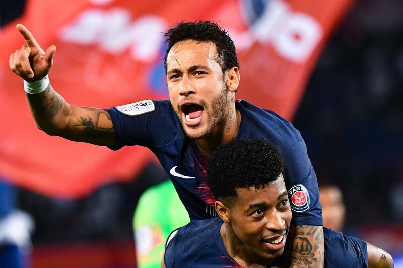Paris Saint-Germain's Brazilian forward Neymar celebrates with teammate Presnel Kimpembe. AFP