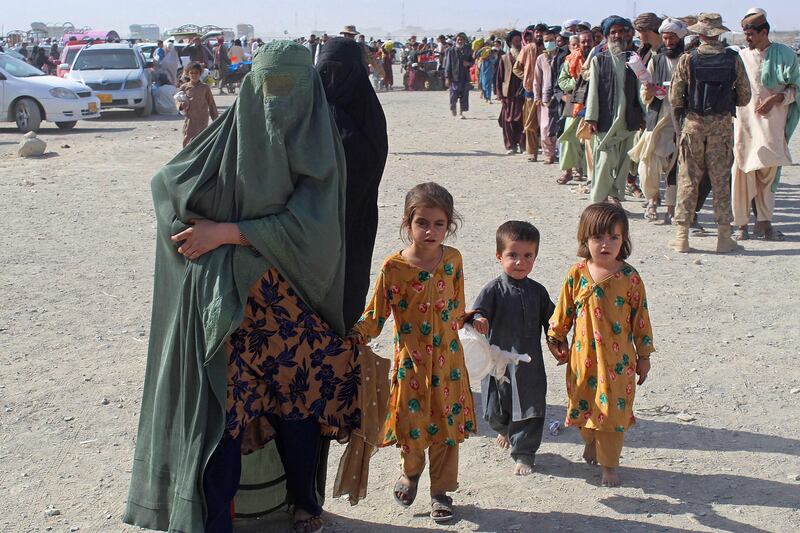An Afghan family arrives at the Pakistan-Afghanistan border crossing point in Chaman. AFP