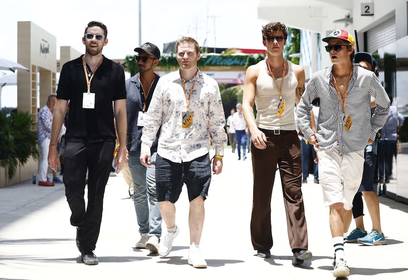 Pop star Shaun Mendes, second from right, walks in the paddock prior to the F1 Grand Prix of Miami. AFP
