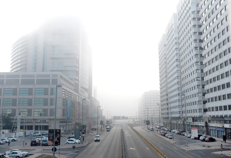 Residents woke up in Abu Dhabi on Saturday morning to find the city shrouded by dense fog. Seen here is Abu Dhabi Mall in the Tourist Club Area. Deepthi Unnikrishnan / The National 
