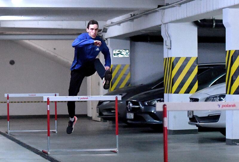 epa08345666 Polish athlete, specialized in the 400 metres and 400 metres hurdles, Patryk Dobek trains in the underground garage at his home during the coronavirus pandemic in Szczecin, Poland, 06 April 2020. Due to the lock-down due to the coronavirus pandemic many athletes do their training routines and exercises at their improvised gym at home.  EPA-EFE/Marcin Bielecki POLAND OUT *** Local Caption *** 56006520
