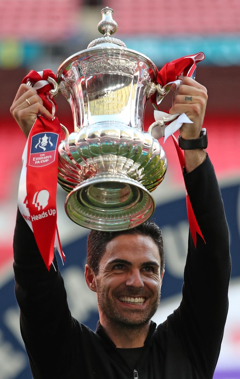 Mikel Arteta holds the FA Cip aloft. AFP