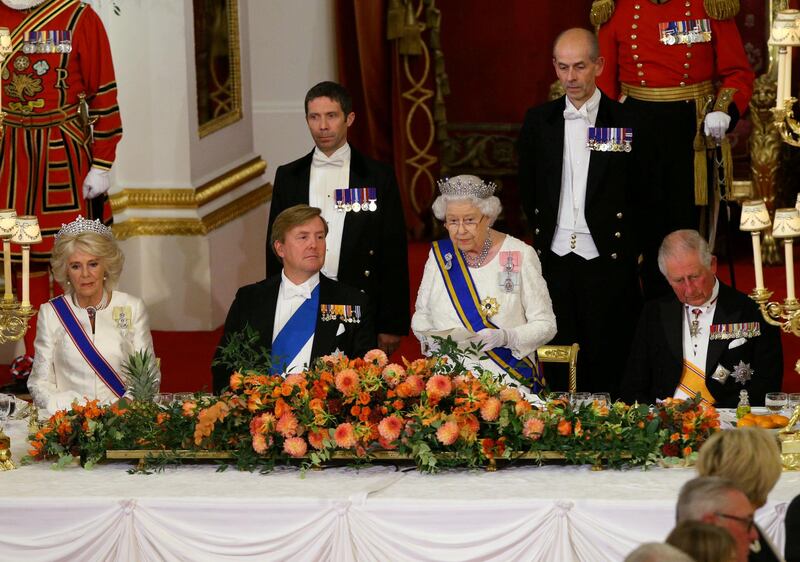 Queen Elizabeth II gives a speech as Camilla, Duchess of Cornwall, King Willem-Alexander of the Netherlands and Charles, Prince of Wales listen during a state banquet at the Buckingham Palace in London. Yui Mok / Reuters