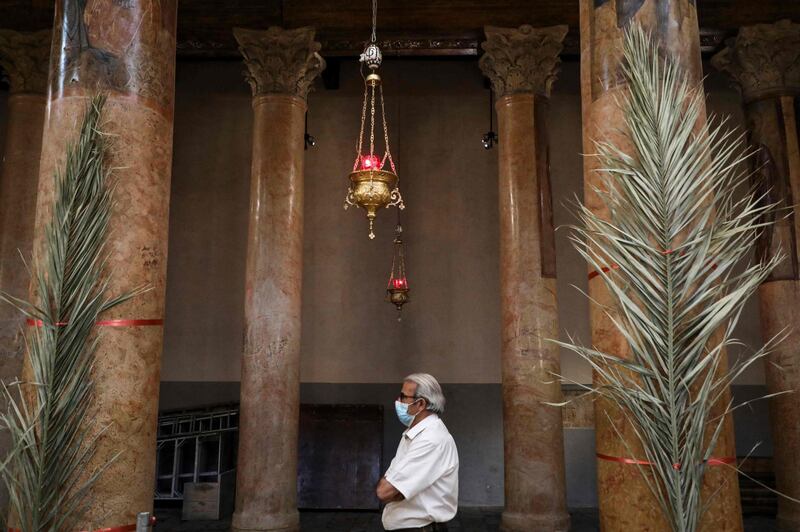 A worshipper attends Palm Sunday celebrations at the Church of the Nativity in Bethlehem in the occupied West Bank. AFP